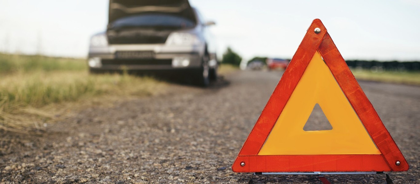 Roadside assistance with emergency warning triangle on highway