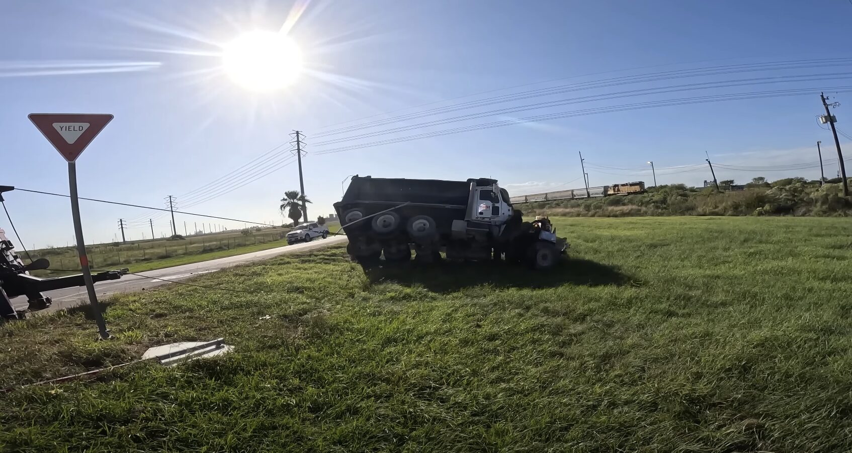 Professional towing truck safely recovering accident vehicle from roadside